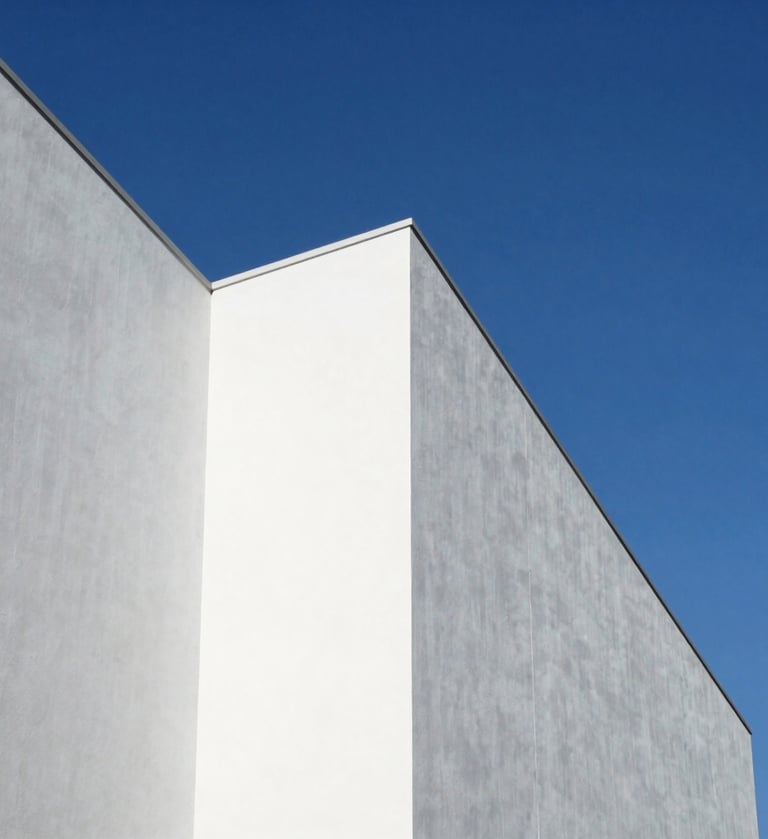 A high-angle architectural photograph of a minimalist white building facade against a clear cerulean blue sky in North America. Sharp, clean shadows create geometric patterns of triangles and rectangles. Bauhaus-inspired composition with a professional, artistic finish.