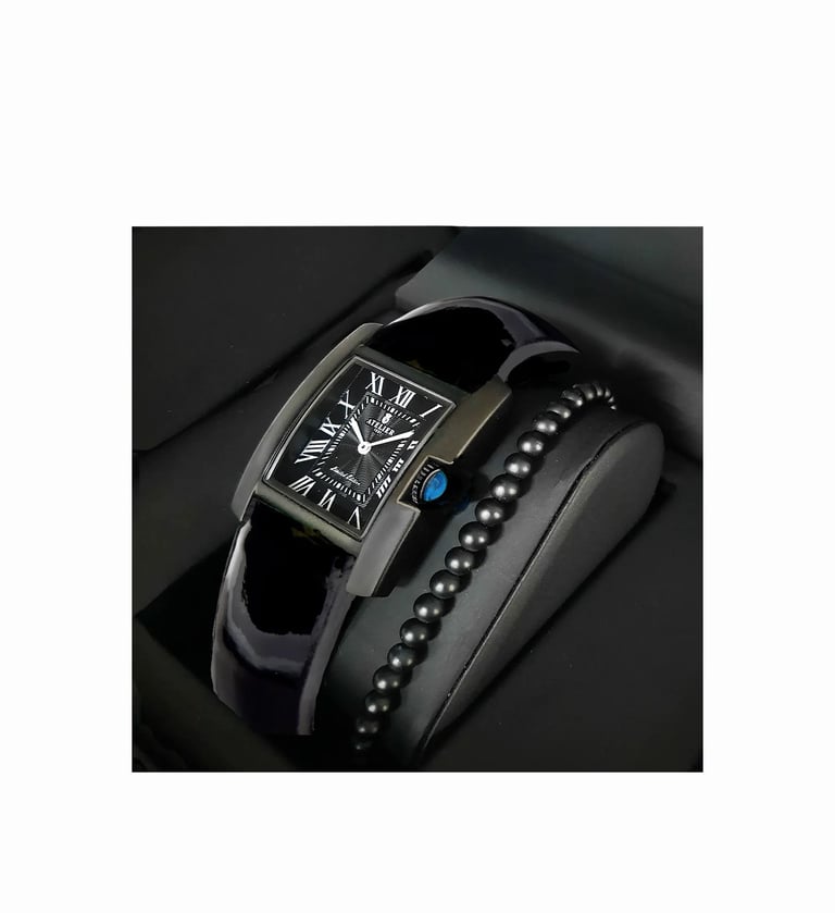 Luxury black tank watch with Roman numerals and matching beaded bracelet in a gift box.