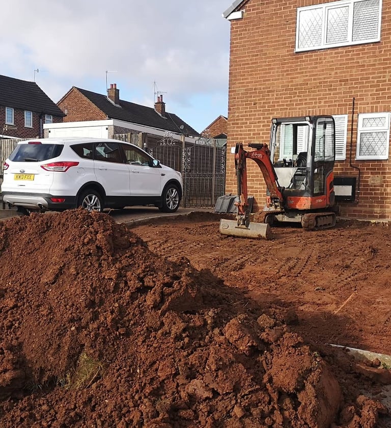 Mini digger in use for drainage work in Oldbury
