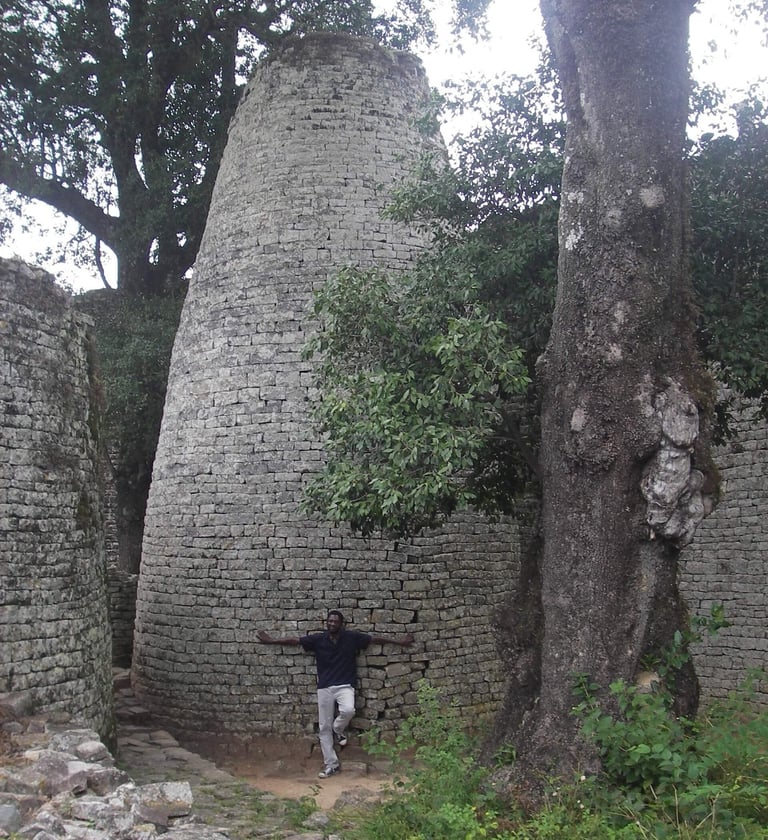 Man leaning on the Great Enclosure tower at Great Zimbabwe
