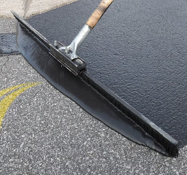 Sealcoating driveway with hand broom