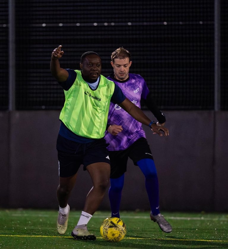 two men playing soccer on a field