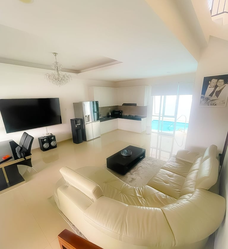 Living room with sofa opening to private pool at Villa Sattara Seminyak, villa for sale Seminyak