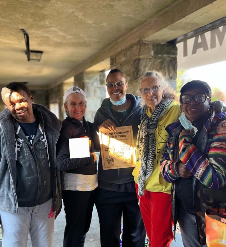 Volunteers taking a picture together in the fridge & pantry area. 