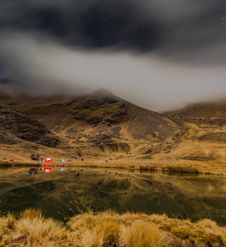 Photographer capturing sunrise reflection of Ausangate Mountain in Laguna Pucacocha, Peru