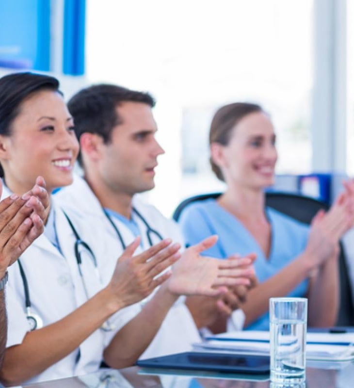a group of doctors and nurses in a conference room
