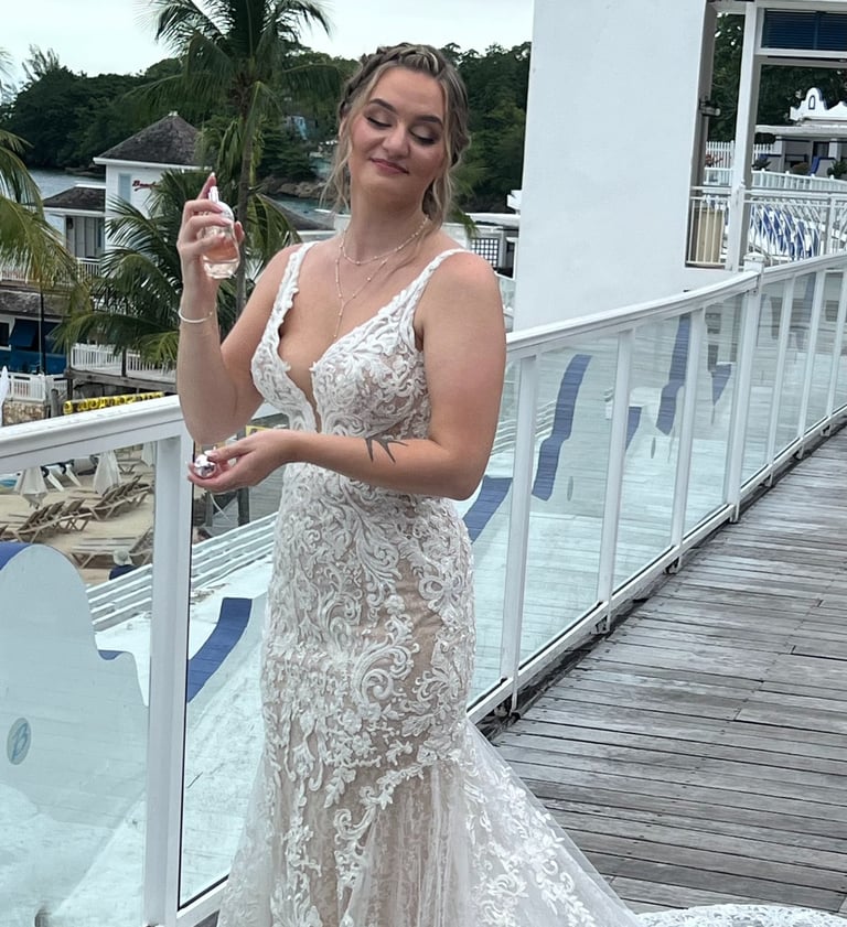 a woman in a white dress standing on a deck