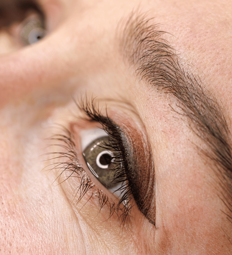 Close-up of client’s eyes with shaded or smudged permanent eyeliner