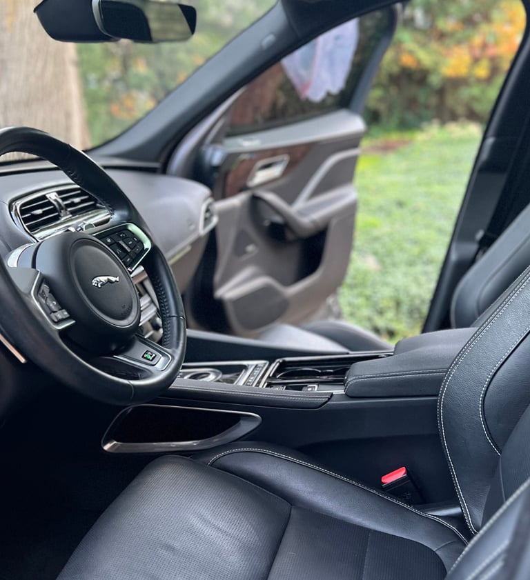 Sanitized SUV interior with clean cupholders and debris-free console