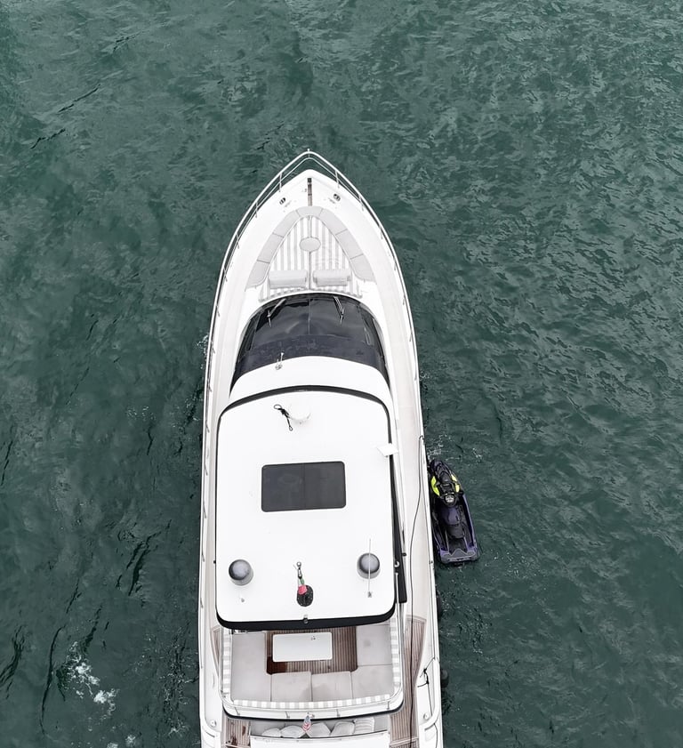 a boat with a man standing on the water