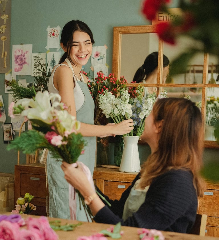 a woman is smiling and holding a bouquet