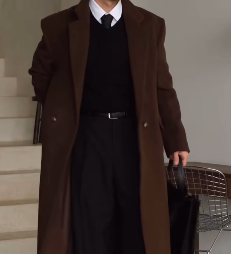 a man in a suit and tie is holding a briefcase
