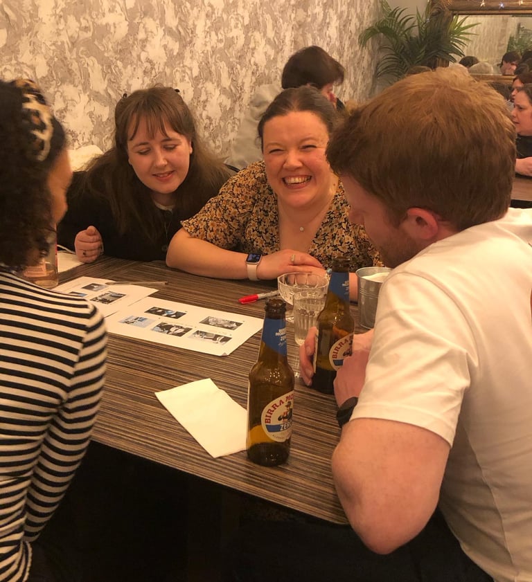 Girl enjoying herself at a quiz night with friends.