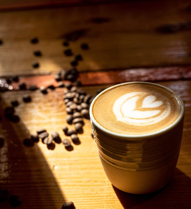 a cup of coffee with a coffee cup in the background
