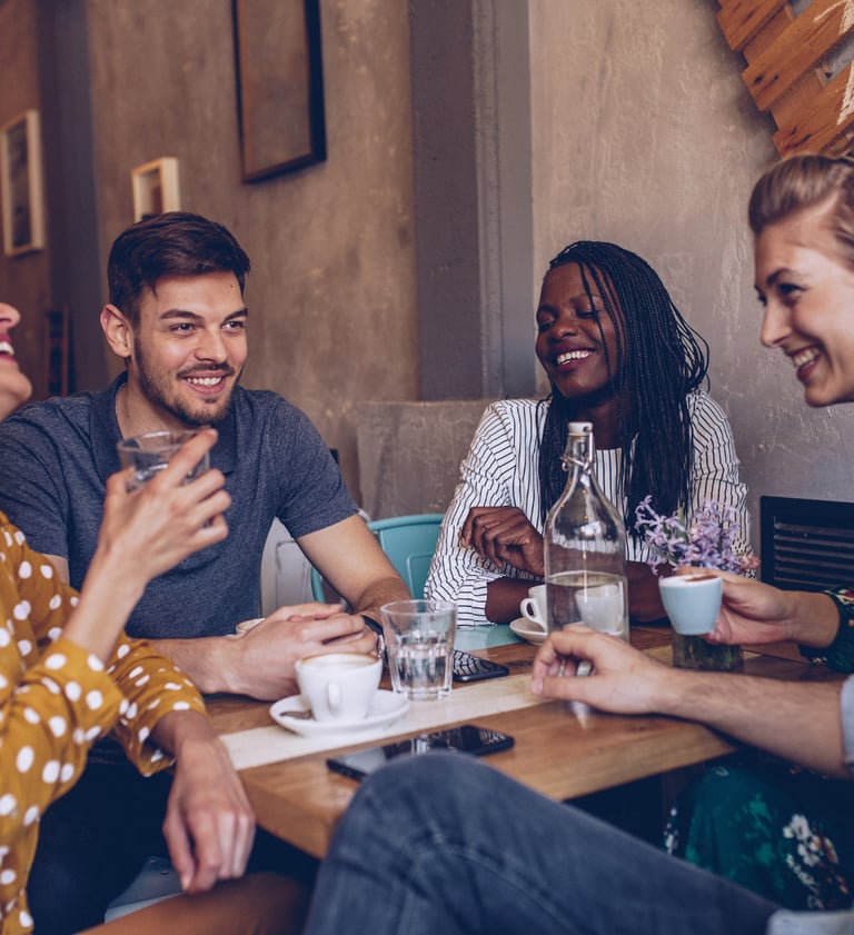 a group of friends having a conversation and connnecting at a restaurant