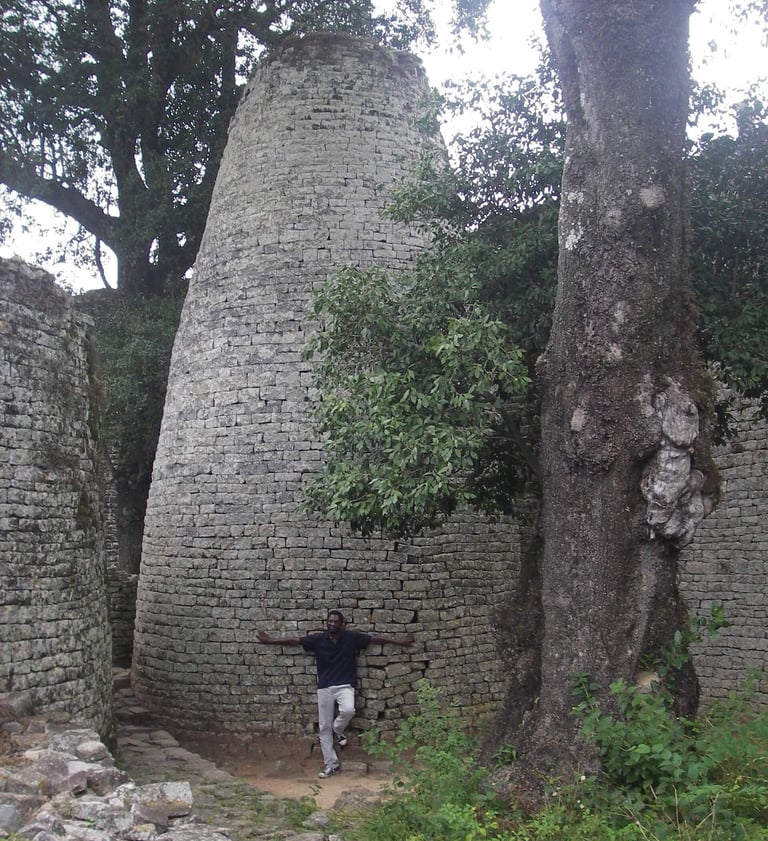 Man leaning on the Great Enclosure tower at Great Zimbabwe