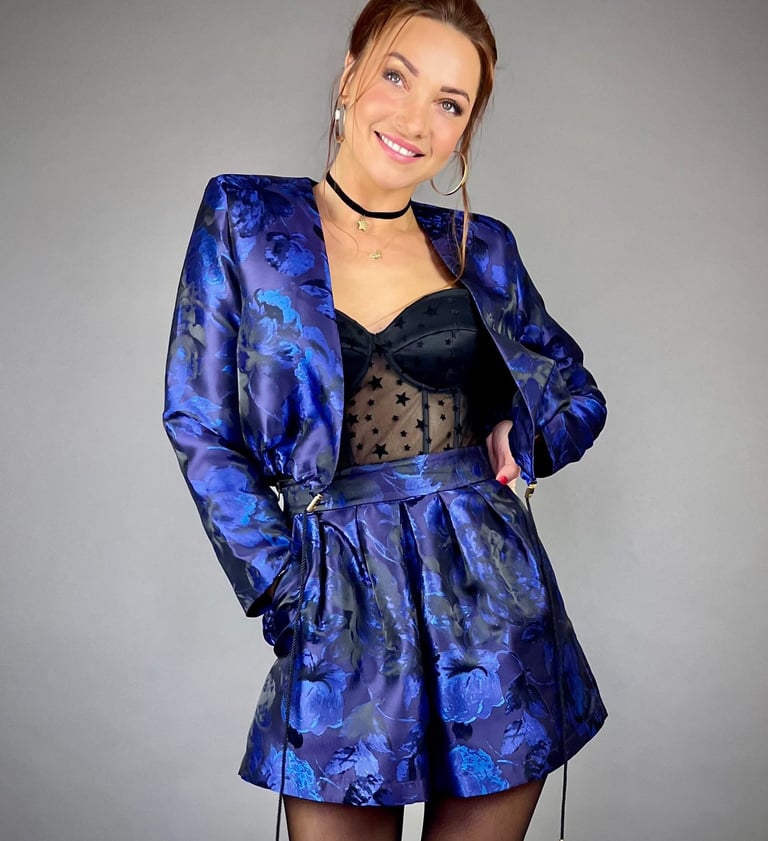 a woman in a blue dress and black stockings
