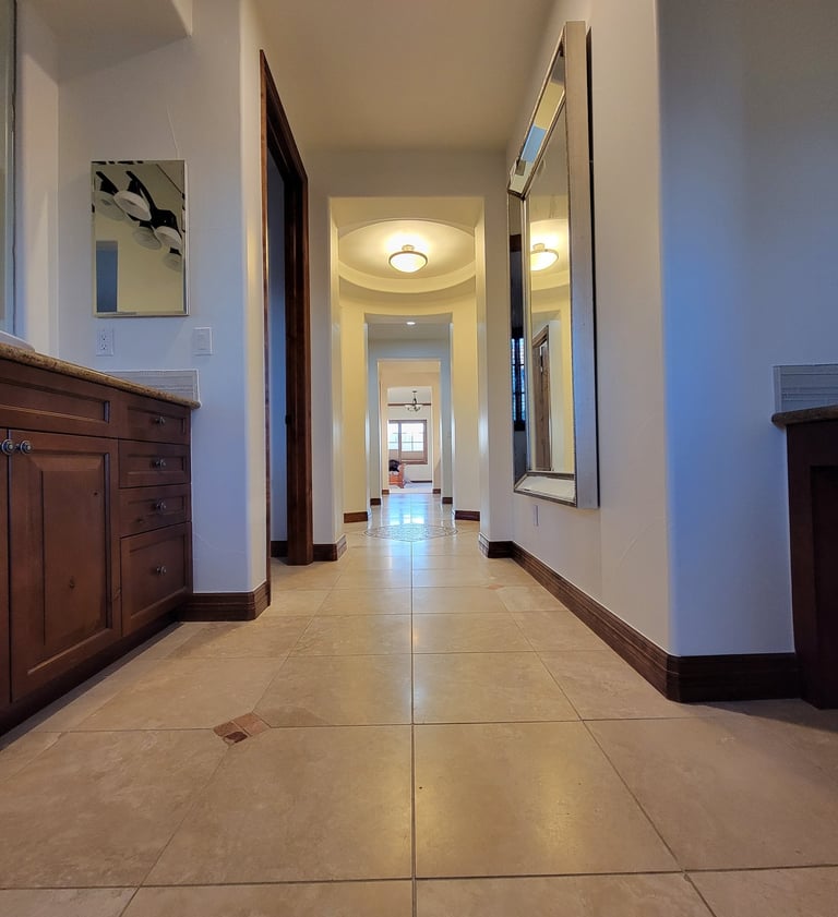 a bathroom hallway with a mirror and a mirror