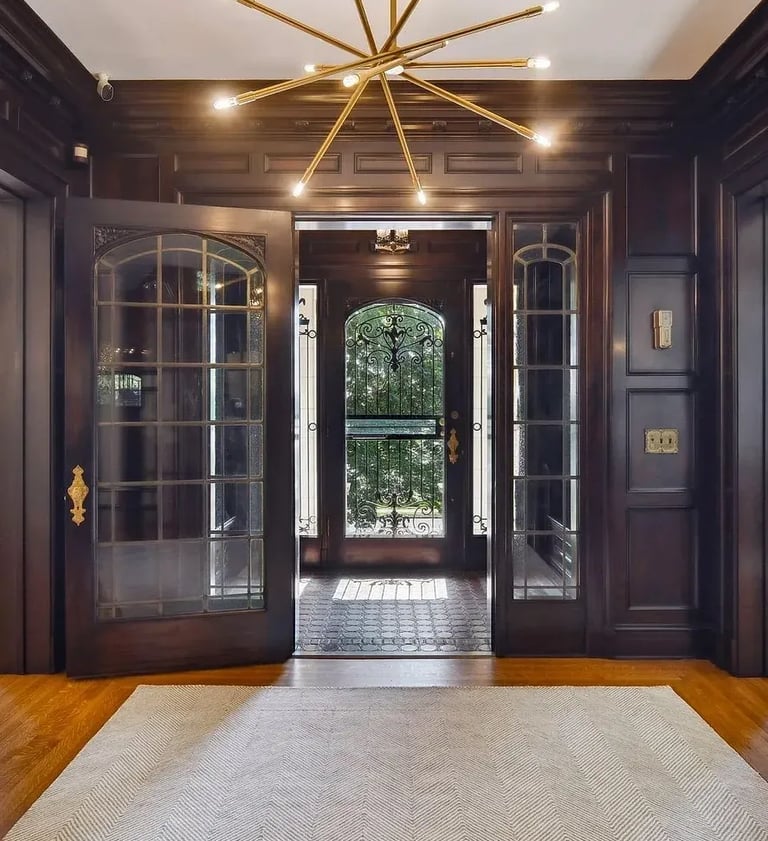 a large foyer with a chandelier and a chandelier