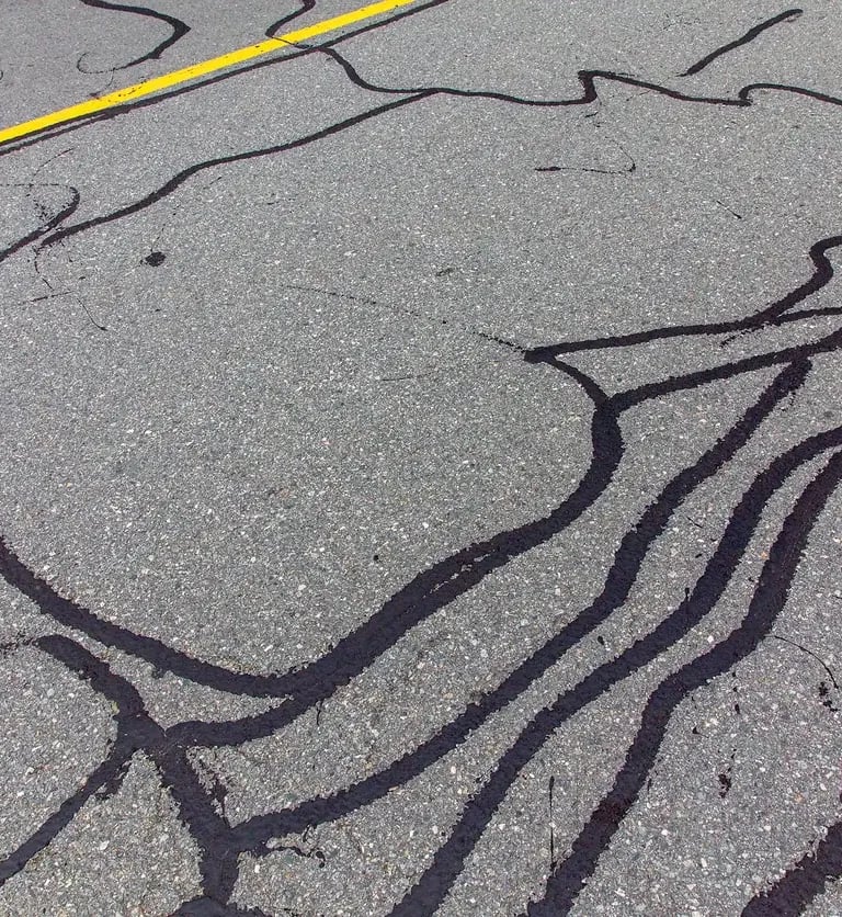 Filled in asphalt cracks in serviced parking lot