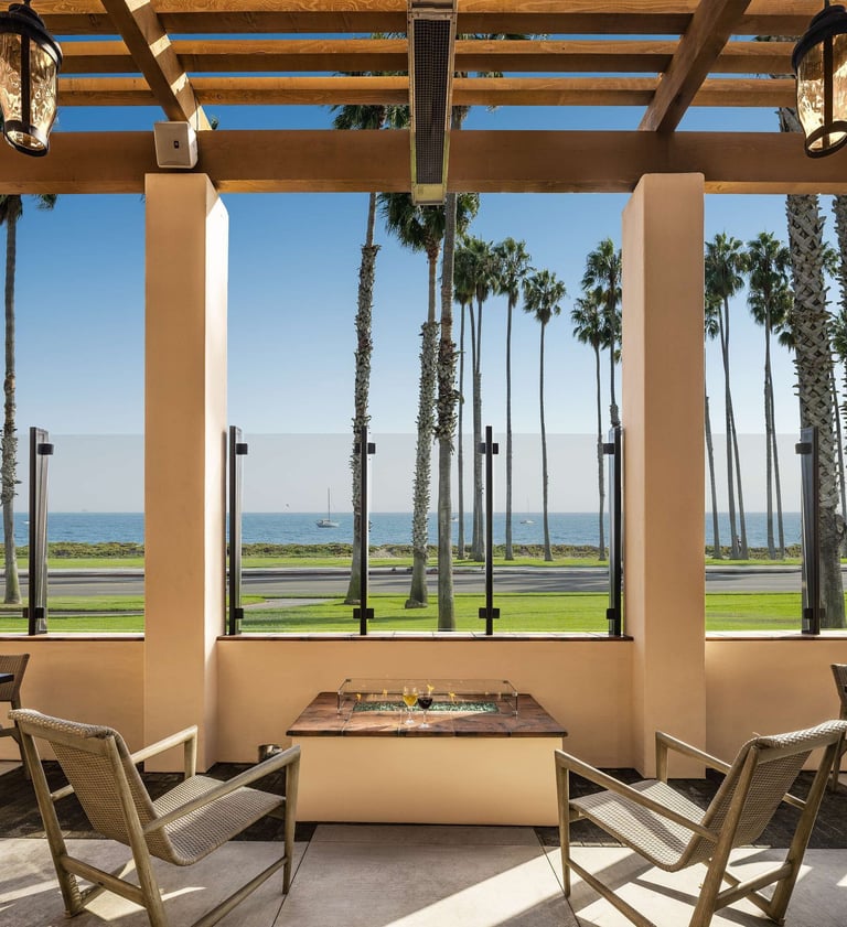 Hilton Santa Barbara Beachfront Resort outdoor lounge with palm trees and ocean view