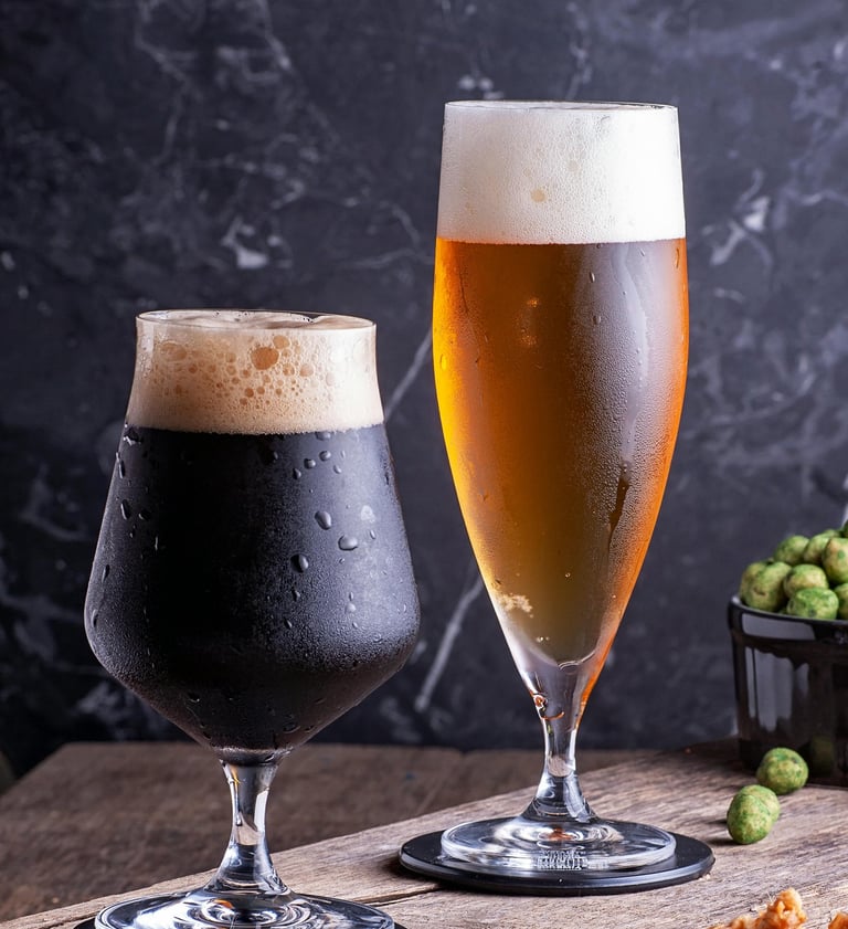 One short glass of stout with a taller glass of lager
