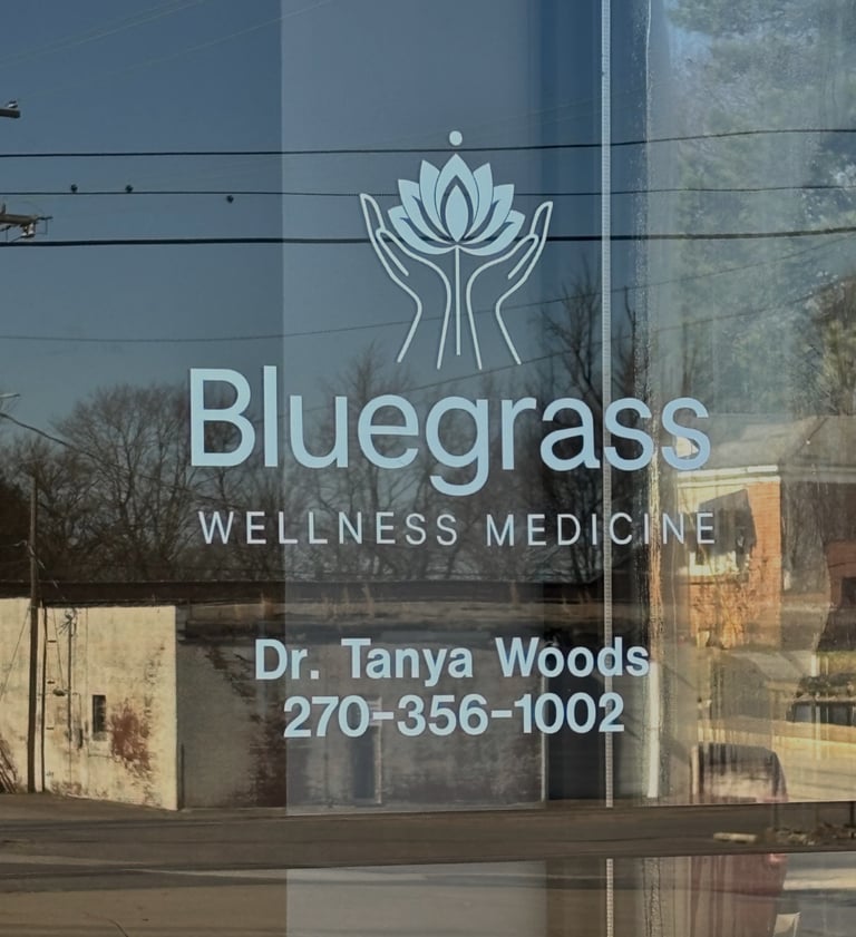 Glass entry door with Bluegrass Wellness Medicine, Dr. Tanya Woods, 270-356-1002 written 