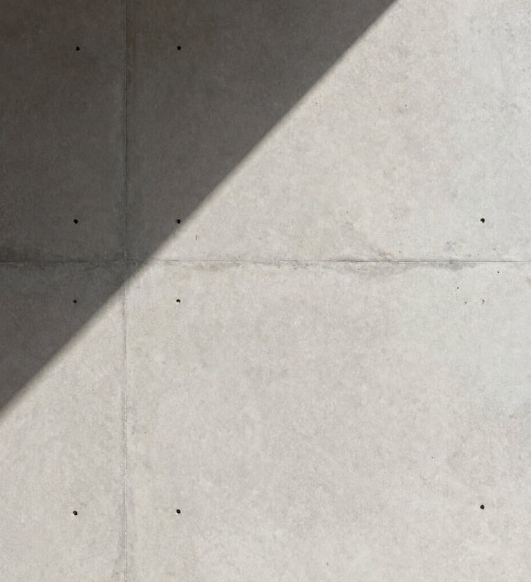 A close-up photograph of a minimalist architectural texture in Brazil, featuring light gray concrete and a sharp, clean diagonal shadow, professional lighting, sophisticated mood.