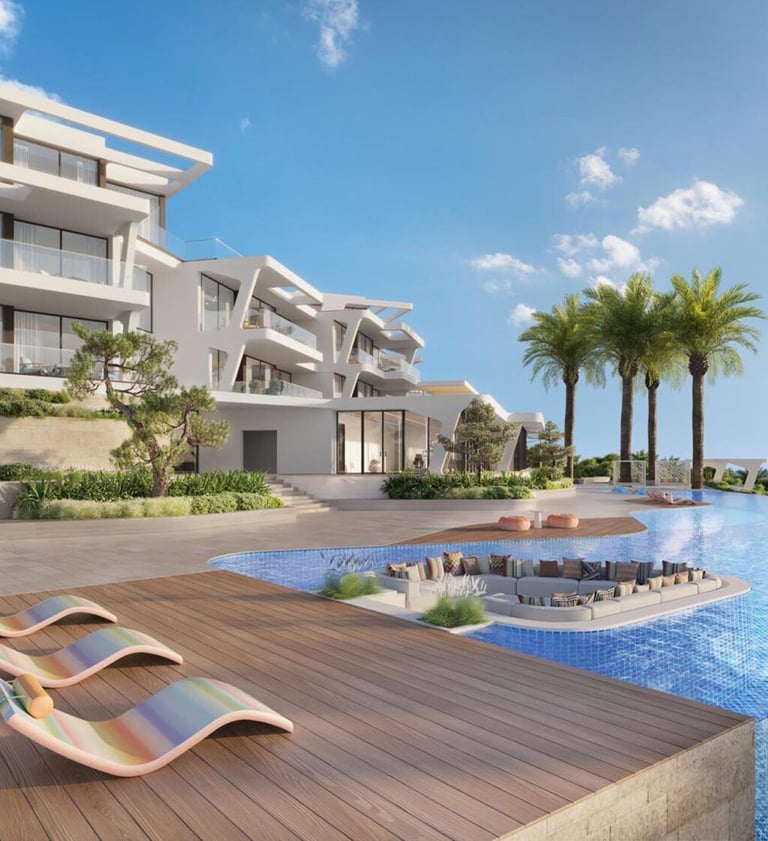 Luxury modern villa with an infinity pool, sun loungers, and ocean views under a blue sky.