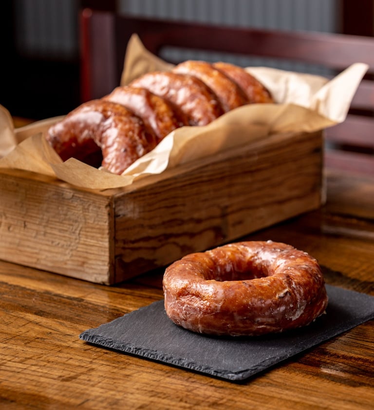 Glazed donuts in a rustic wooden box