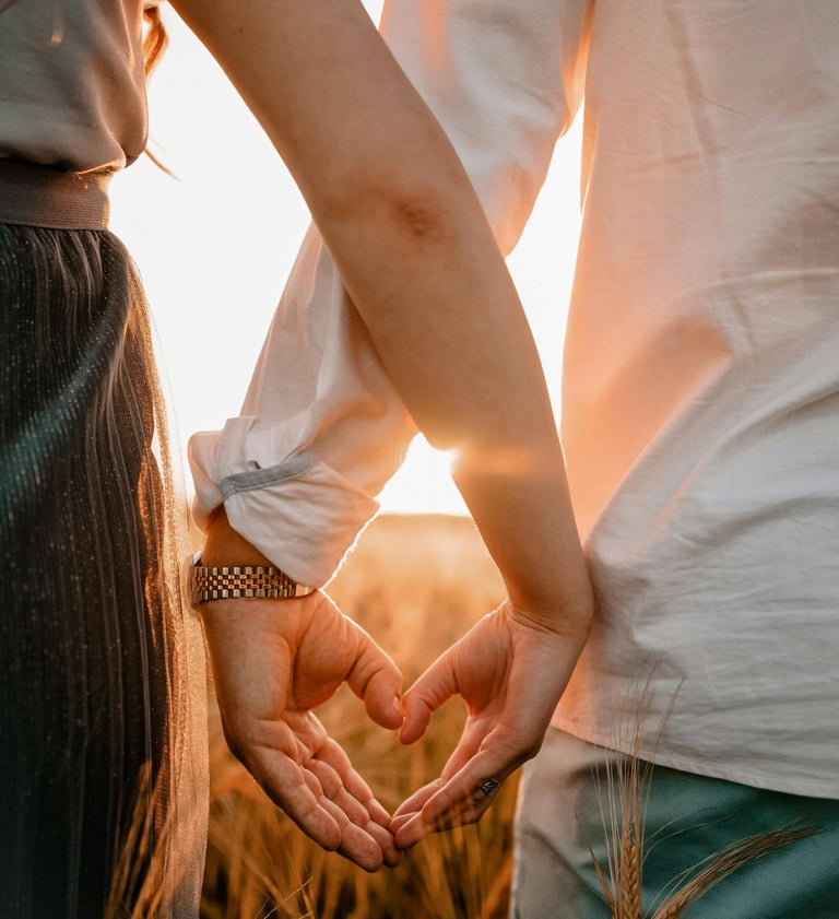 a couple holding hands in a wheat field