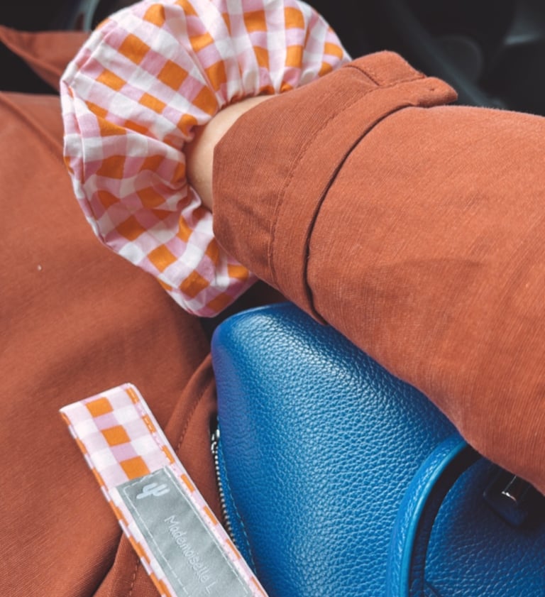 a person holding a blue purse and a blue purse