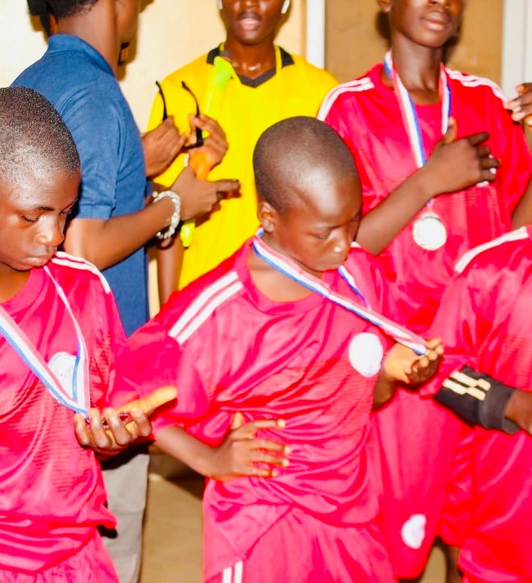a group of young boys are standing in a room