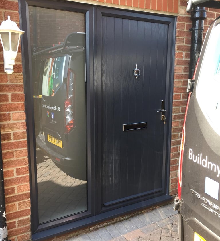 modern composite door with side panel and reflective glass. the door has chrome hardware