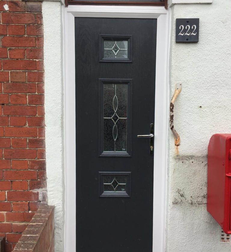 a thin front door fitted on a terrace house in Portsmouth by buildmydoor. black with pattern glass.
