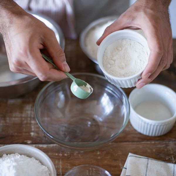 a person is holding a spoon and spoon in their hands