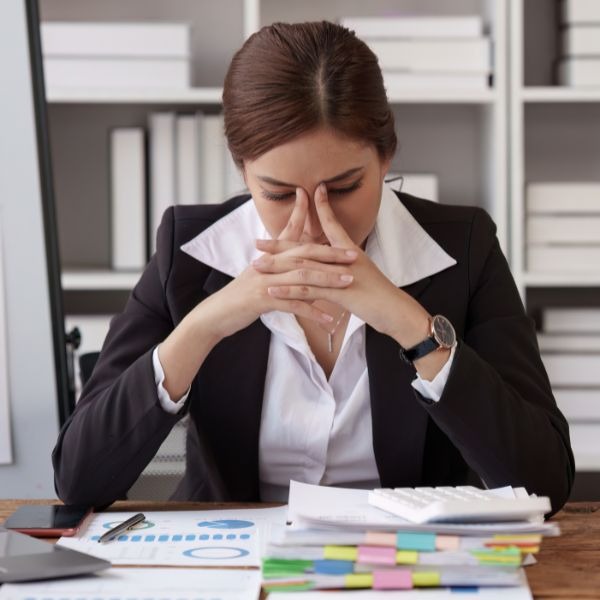 a woman in a business suit sitting at a desk