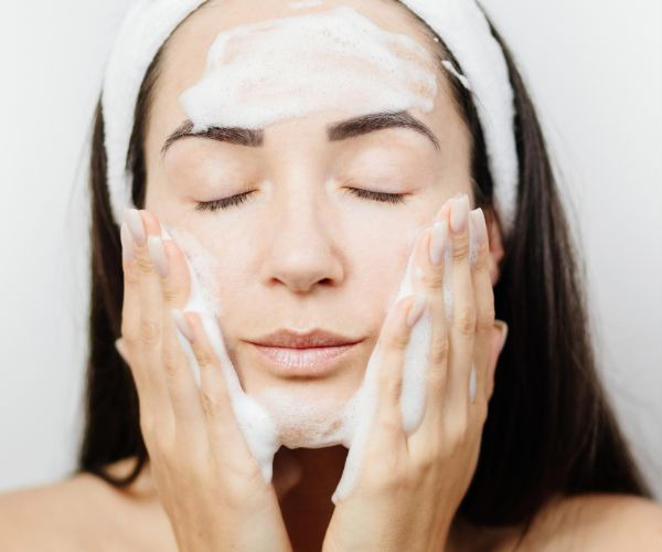 woman washing her face