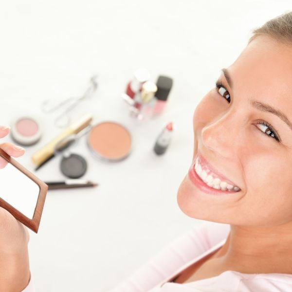 a woman holding a mirror in her hand