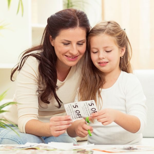 woman clipping coupons