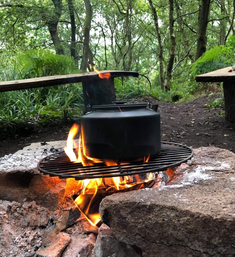 a kettle kettle on a grill with a kettle on it