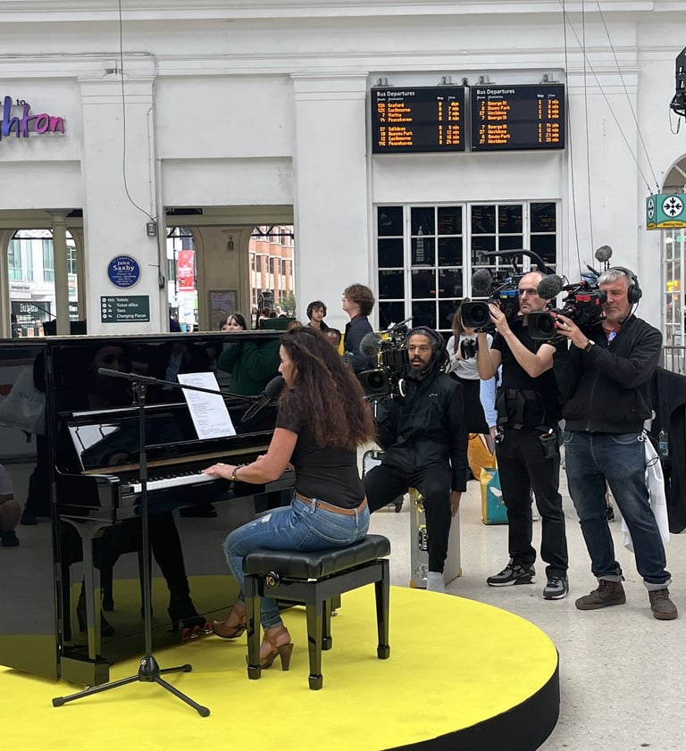 Helen Spooner performing "Sweet Child O' Mine" at Brighton Station for The Piano on Channel 4