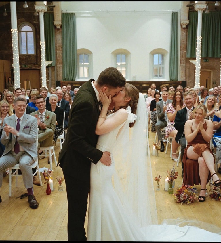 Couple Kissing At Their Wedding Ceremony By David Allbutt