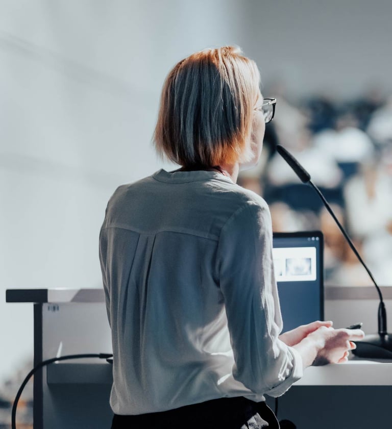 Conference microphone rental for live events in Dubai – speaker at podium using gooseneck mic