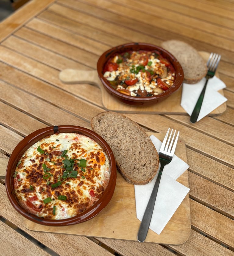 a bowl of food on a table with bread