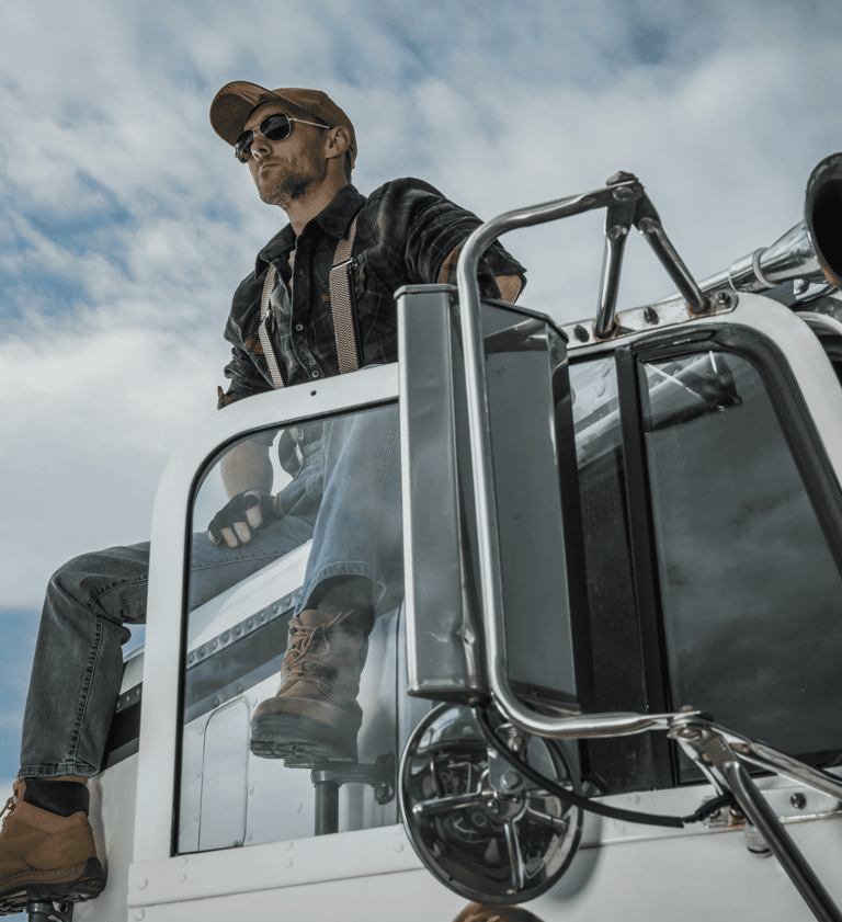 Happy Australian truck driver on cab using Safee NHVR-approved Electronic Work Diary EWD for fatigue compliance.