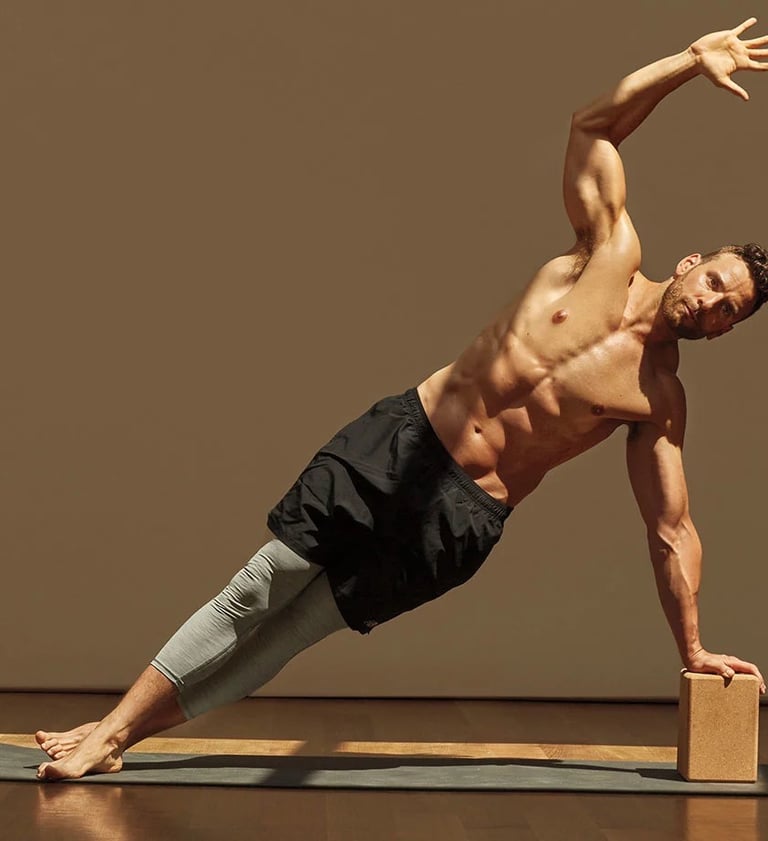 a man doing a yoga pose on a yoga mat