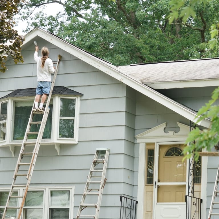 Exterior painters painting a home in Carrollton, TX