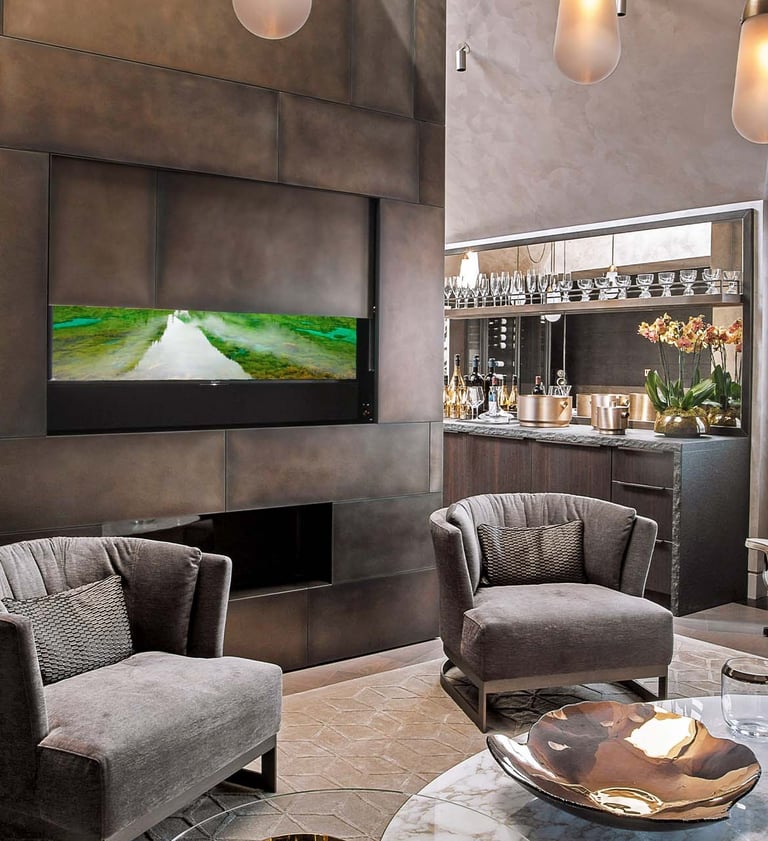 Bespoke media wall featuring an automated drop-down moving panel to conceal a large TV in apartment