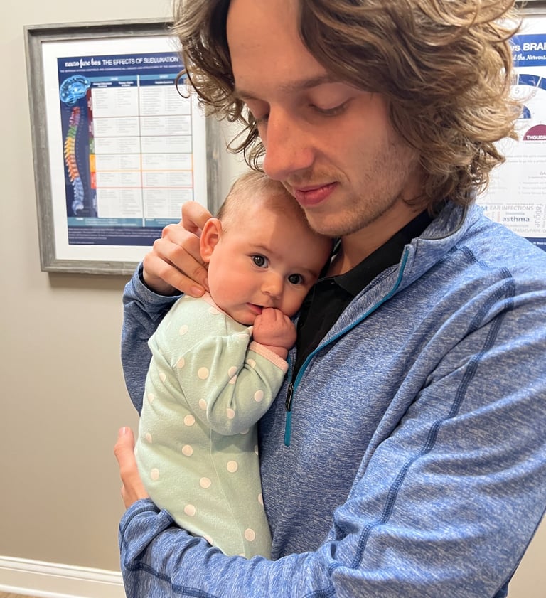Happy baby falling asleep during their adjustment by Franklin pediatric chiropractor
